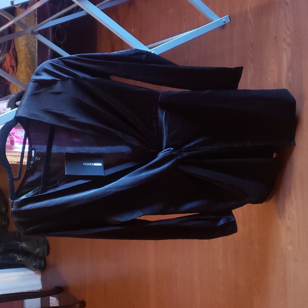 A black fashion nova dress with a plunging neckline.